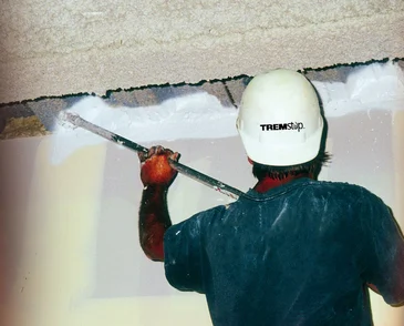 TREMstop® Fyre-Sil sealant is professionally applied as an example of a passive fire protection (PFP) product.